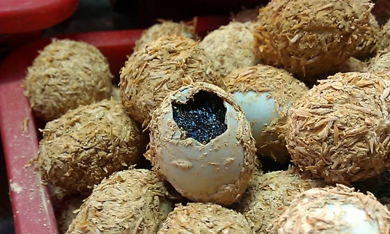 Century eggs coated in a caustic mixture of mud and rice husk