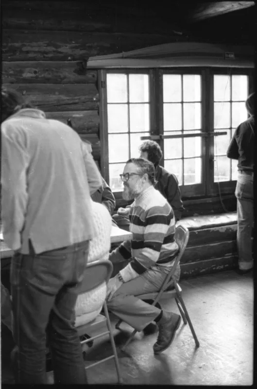 Ritchie conversing in a chalet in the mountains surrounding Salt Lake City