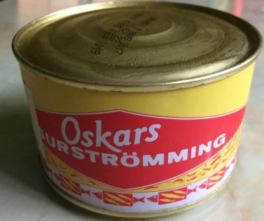 A can of Surströmming, with the top noticeably bulging due to fermented gases being released