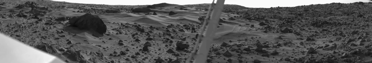Dunes and large boulder. Pole in the center is an instrument boom.