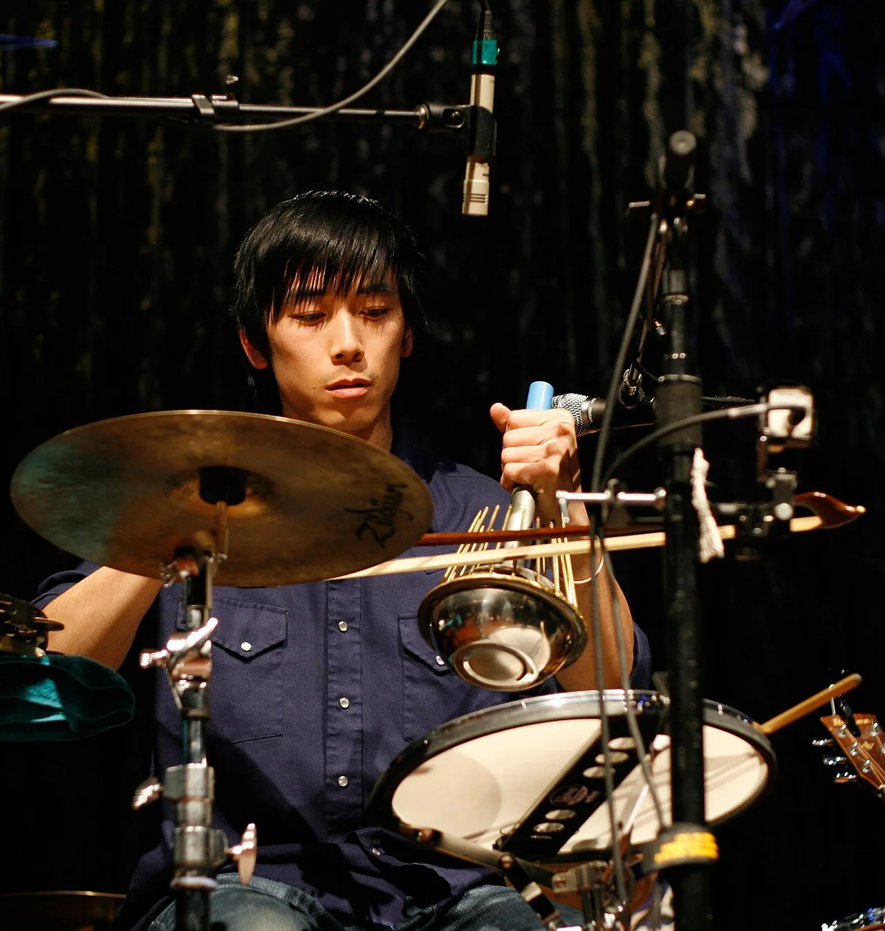 Percussionist Alex Wong bowing a Standard waterphone