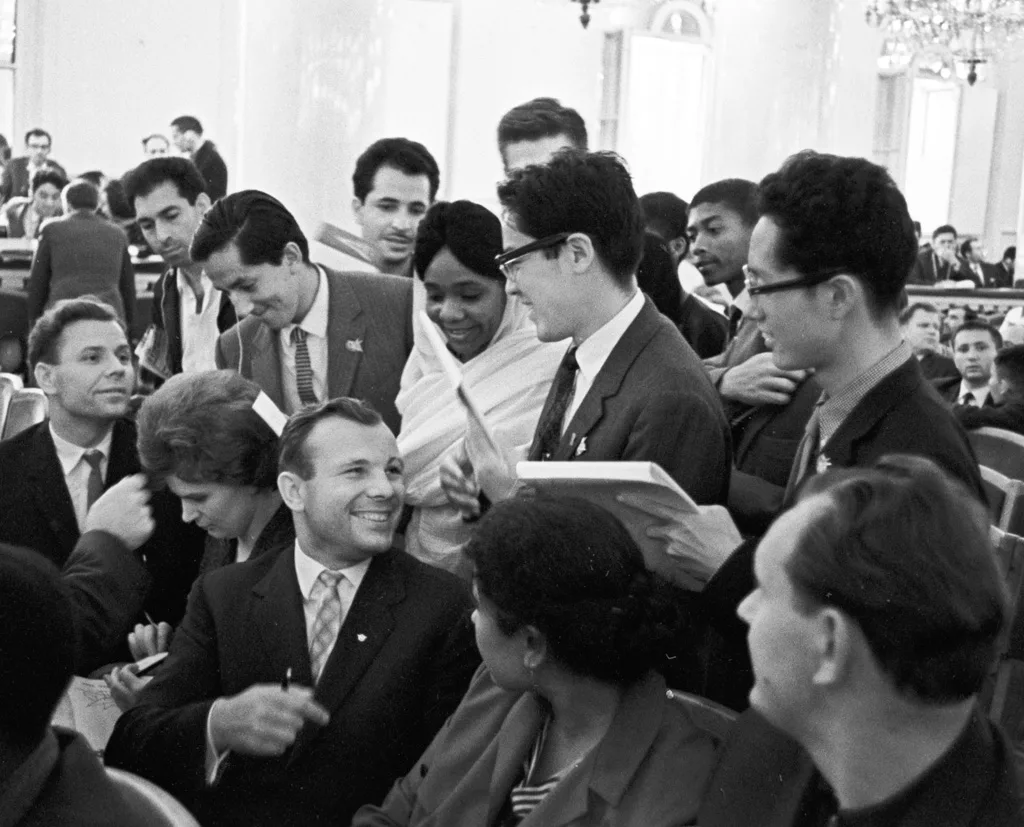 Gagarin and Valentina Tereshkova (seated to his right) signing autographs at a youth forum in 1964